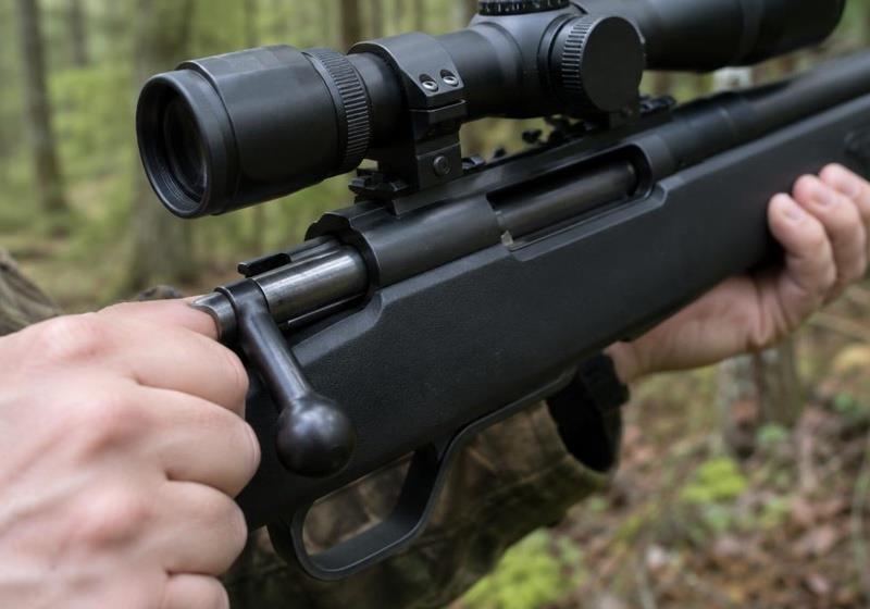 Player pulling the bolt handle of a spring-powered airsoft sniper rifle